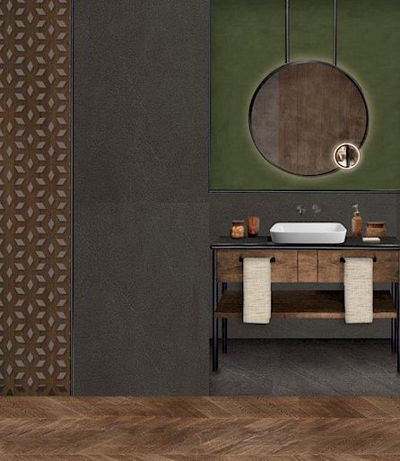 Modern bathroom design featuring a wooden vanity, round mirror, and green accent wall.