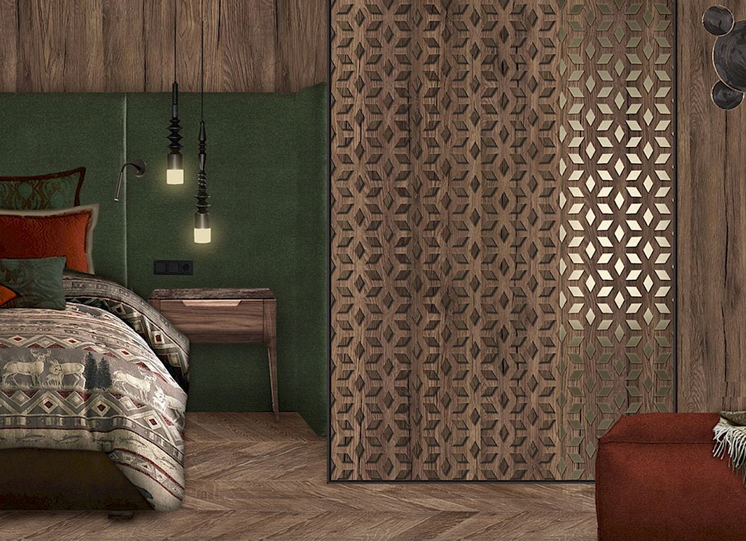 Chambre chaleureuse avec murs en bois, literie à motifs, lampes modernes et un pouf rouge.
