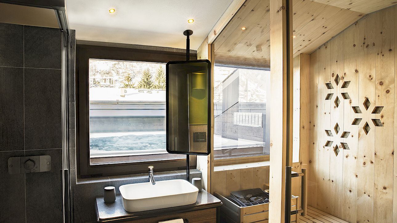 Modern bathroom with sink and sauna, wood paneling, snowflake wall design.
